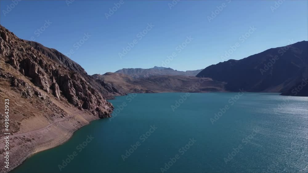Slowly pan to the right aerial shot of the El Yeso dam artificial reservoir Slowly pan to the right aerial shot of the El Yeso dam artificial reservoir