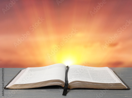 Obraz na plátně Open Holy Bible on table outdoors