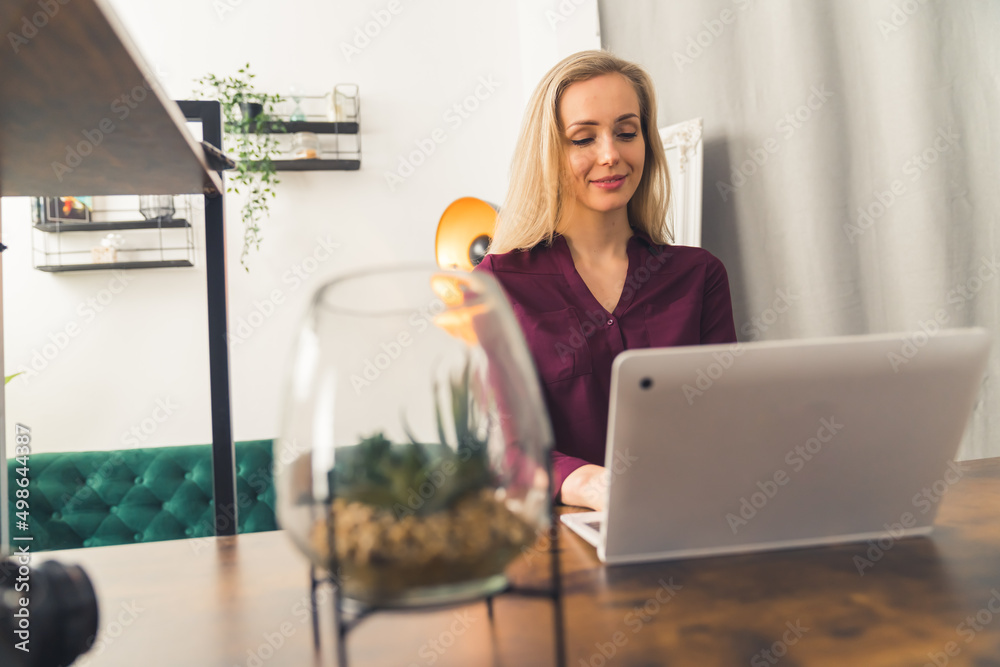 beautiful blonde Caucasian girl working from home medium closeup indoors living room remote job concept . High quality photo beautiful blonde Caucasian girl working from home medium closeup indoors living room remote job concept . High quality photo