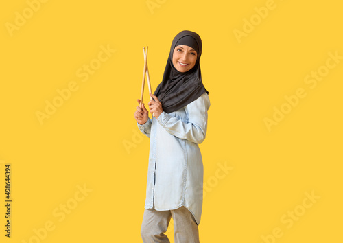 Muslim music teacher on color background