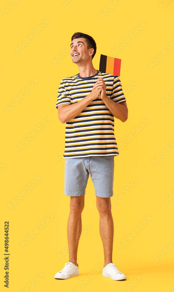 Young man with flag of Belgium on color background Young man with flag of Belgium on color background