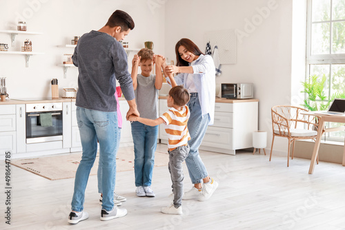 Happy  family dancing in ki...