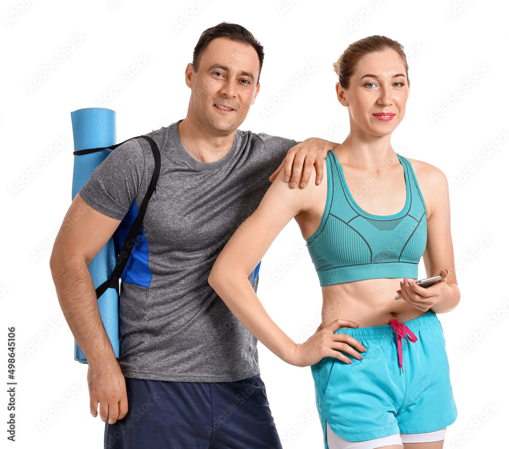 Sporty couple with yoga mat on white background Sporty couple with yoga mat on white background