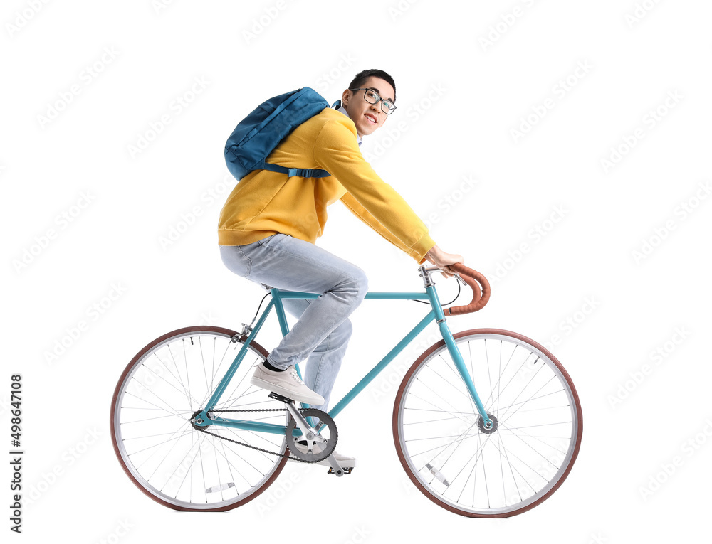 Obraz premium Male Asian student riding bicycle on white background