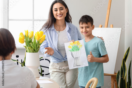 Cute boy and teacher during...