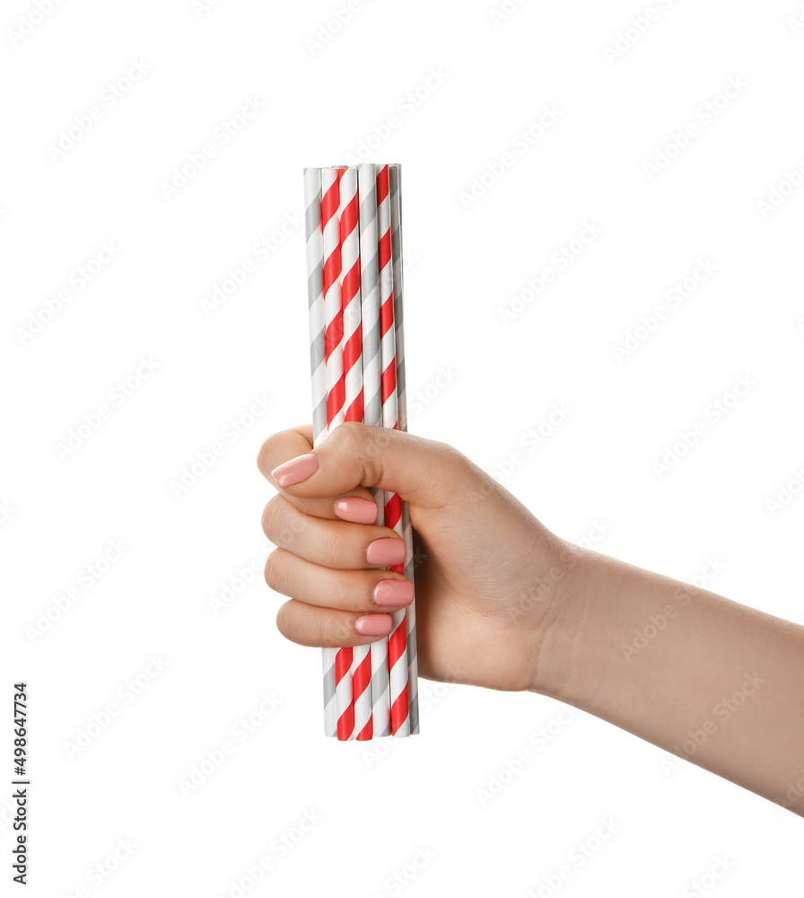 Obraz premium Female hand with stylish straws for drinks on white background