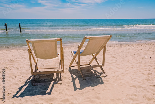 Two chairs on the beach near the sea. © Diana Vyshniakova