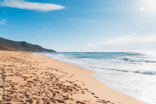 View of mountains and sand from the beach of Scivu, Marina di Arbus, Sardinia, Italy