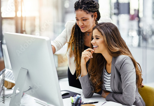 That looks good. Cropped shot of two attractive young businesswomen working at a desk in their office.
