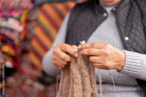 Hands weaving weaving baby alpaca wool in a handicraft shop