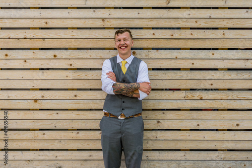 Modern groom in urban downtown, grey suit, grey and yellow