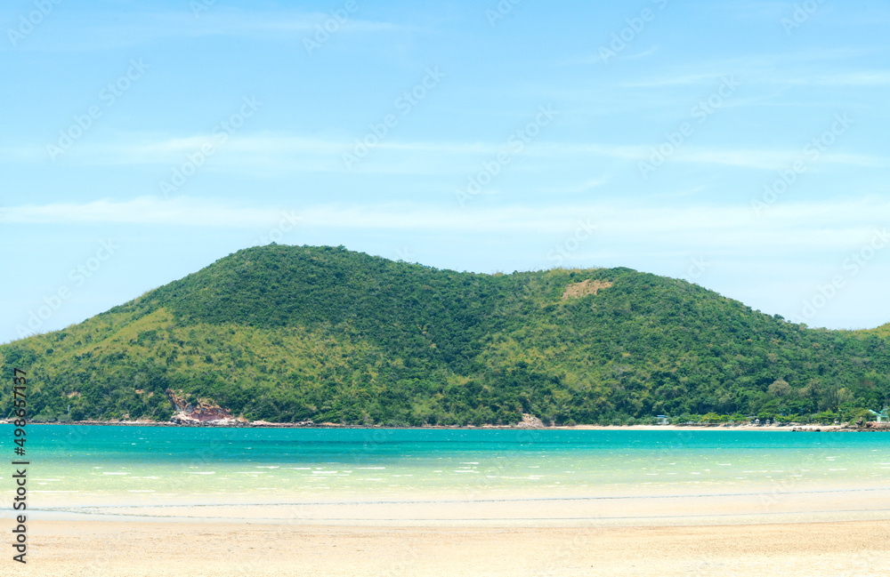Panorama landscape beach background in Thailand.light blue sky, green mountain background, sea wave and sand beach in pastel style. Concept of summer vacation and holiday tourism.