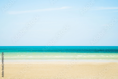 Landscape beach background in Thailand.light blue sky  sea wave and sand beach in pastel style. Concept of summer vacation and holiday tourism.