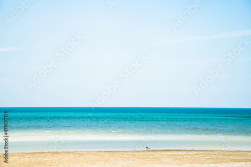 Landscape beach background in Thailand.light blue sky  sea wave and sand beach in pastel style. Concept of summer vacation and holiday tourism.