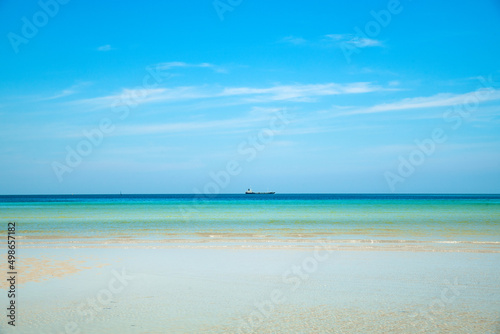 Landscape beach background in Thailand.light blue sky, sea wave and sand beach in pastel style. Concept of summer vacation and holiday tourism. © simpletun