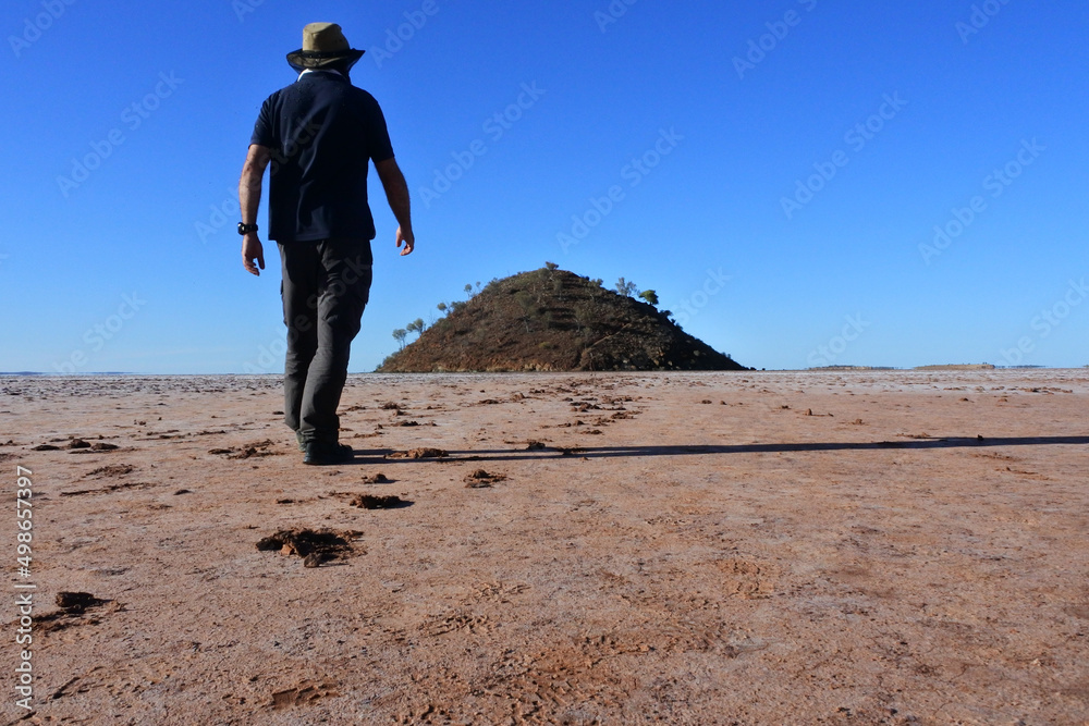 Australian man walking into the landscape view of lake Ballard  Western Australia