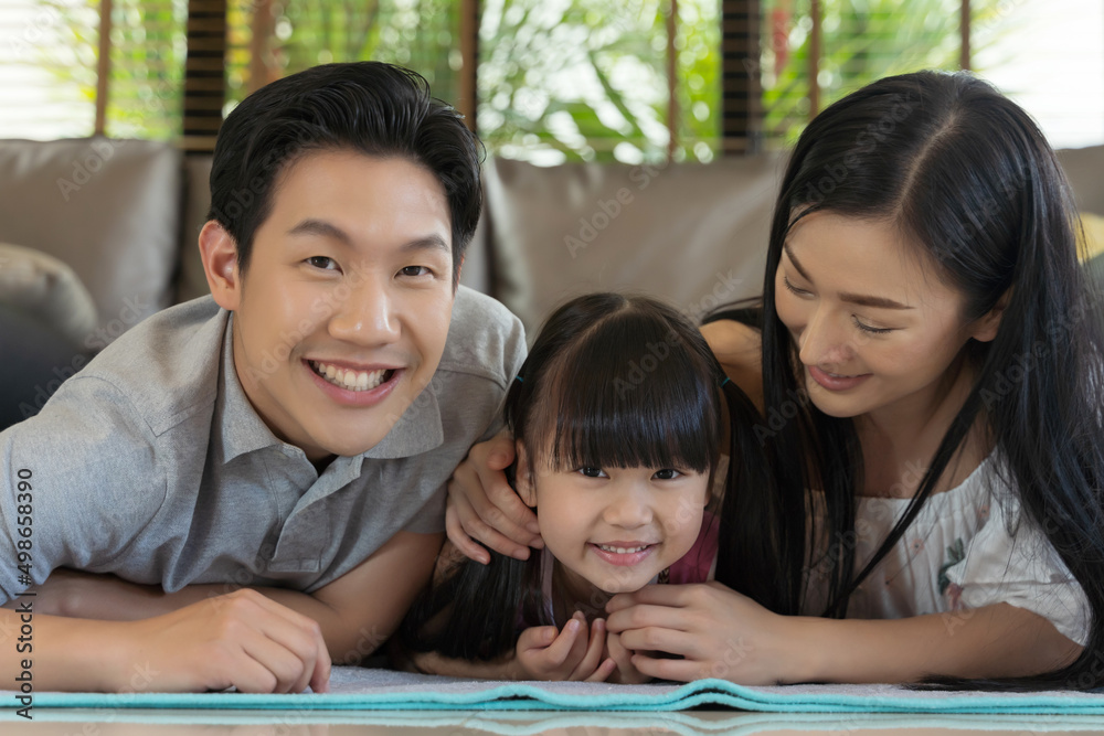 Portrait of happy asian family spending time together in living room. family and home concept Portrait of happy asian family spending time together in living room. family and home concept