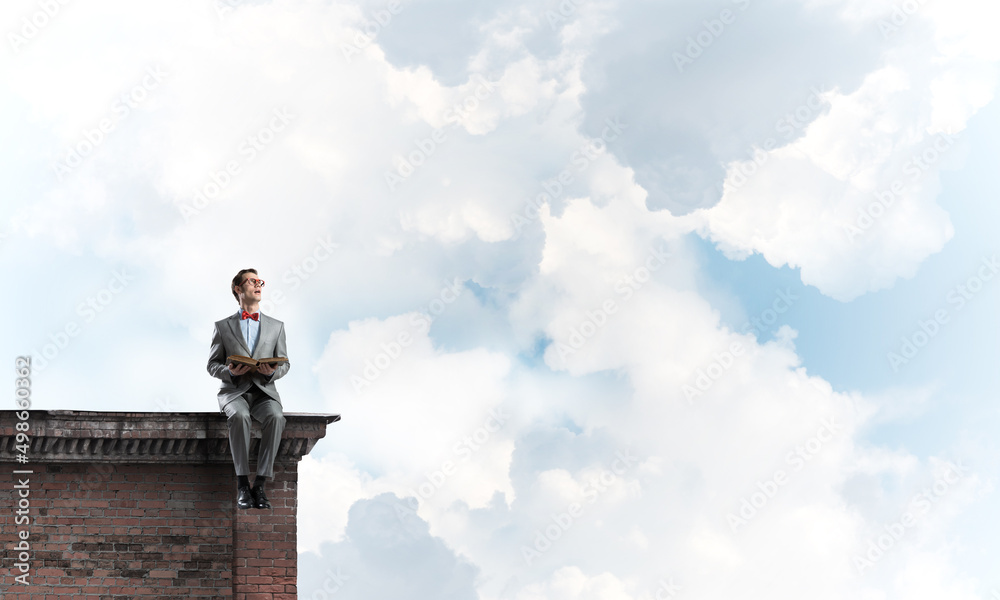Young businessman or student studying the science on building roof Young businessman or student studying the science on building roof