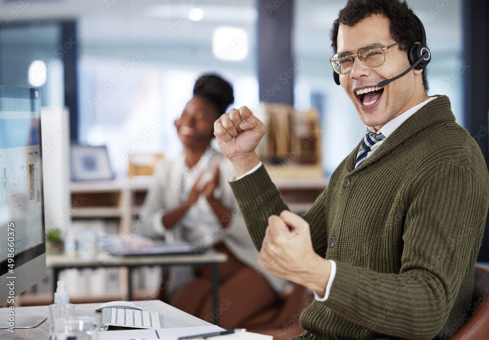 When one of us wins, we all win. Shot of a two colleagues celebrating success in an office at work. When one of us wins, we all win. Shot of a two colleagues celebrating success in an office at work.
