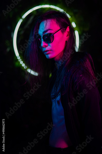 Portrait of asian man wearing sunglasses in neon light. 