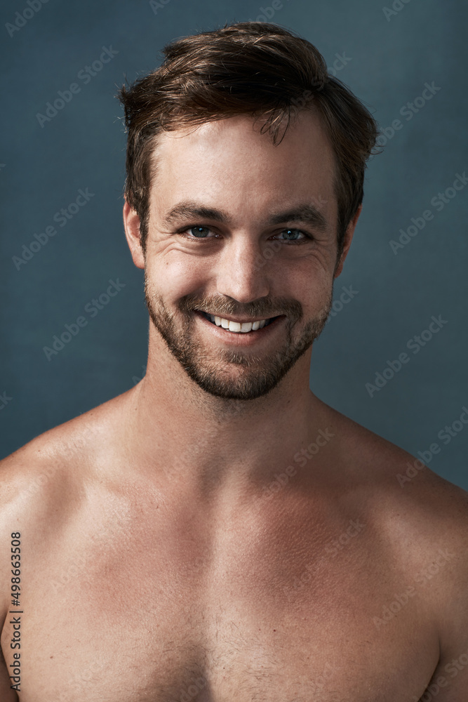 Fototapeta premium Even men should take care of their skin. Cropped portrait of a handsome young man against a grey background.