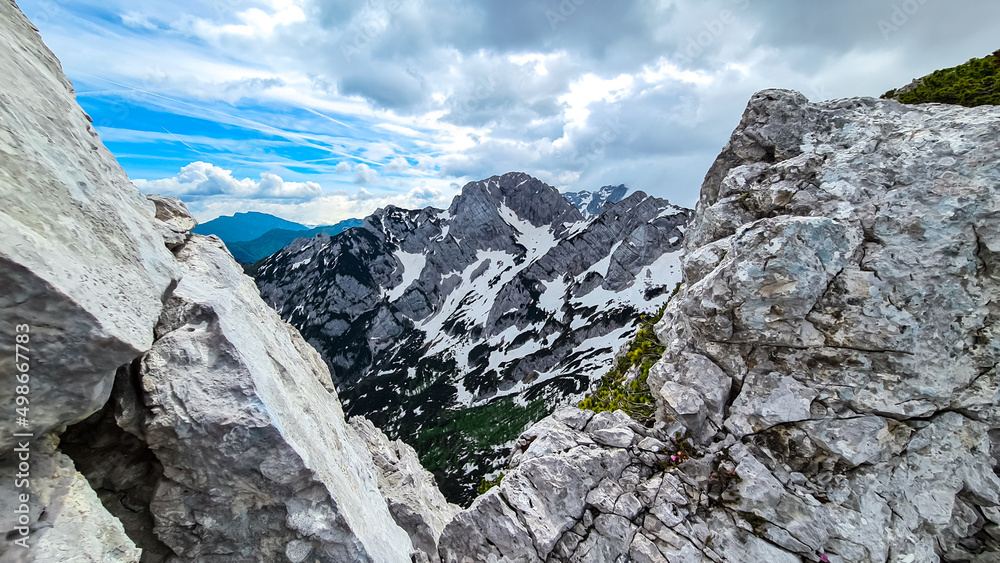 Panoramic views on the sharp and rocky mountain peaks of the Kamnik Savinja Alps in Carinthia, border Austria, Slovenia. Mountaineering. Freedom wanderlust hiking concept. Look at Vellacher Kotschna