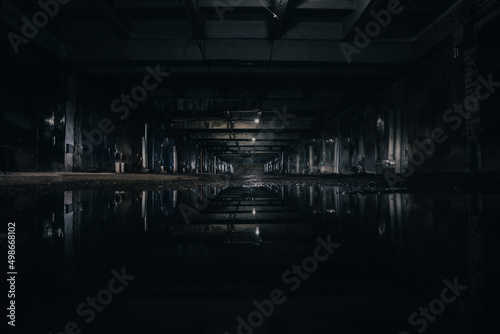 abandoned underground parking, underground warehouse at night photo