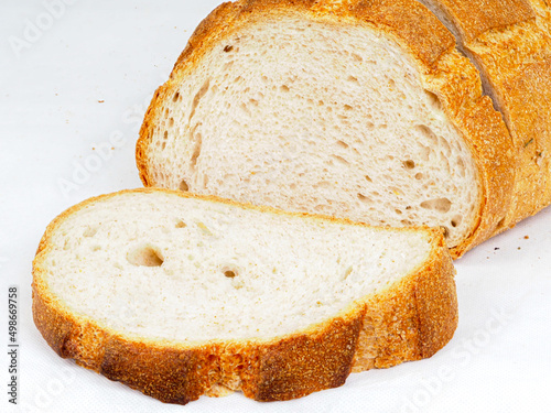 golden rustic wheat bread on white background  photo