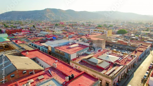Oaxaca, Mexico. Drone Flying Above Vibrant Colorful Latin Colonial Buildings During Beautiful Golden Hour Sunset. photo