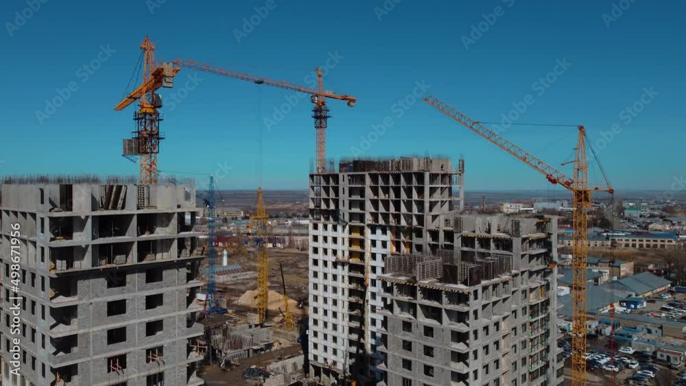 Construction machinery and cranes on site. Construction of new housing. Mortgage. Building industry