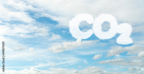 CO2 symbol on blue sky and white clouds. CO2 emissions. Greenhouse gas. Carbon dioxide gas global air climate pollution. Environment issue. Background for carbon capture and storage technology.