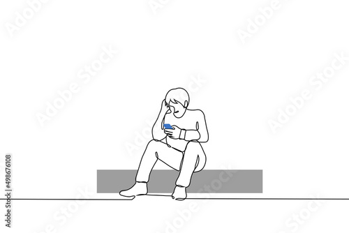 man sits on curb and looks into the phone scratching his head with his free hand, he is puzzled or even sad - one line drawing vector.  concept of news intoxication, news reading, internet surfing