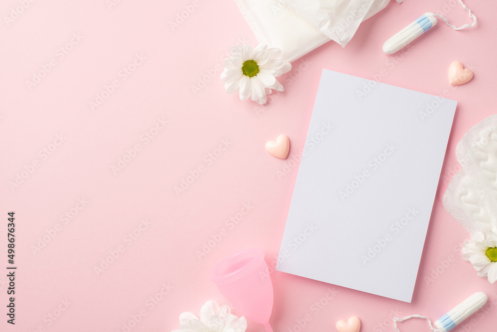 Top view photo of paper sheet pink hearts camomile buds menstrual cup hygienic pads and tampons on isolated pastel pink background with empty space Top view photo of paper sheet pink hearts camomile buds menstrual cup hygienic pads and tampons on isolated pastel pink background with empty space