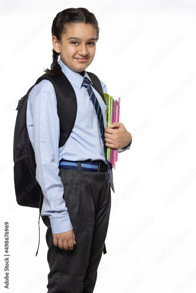 young girl from primary school standing walking in the school holding books notebook and school bag isolated on white background young girl from primary school standing walking in the school holding books notebook and school bag isolated on white background