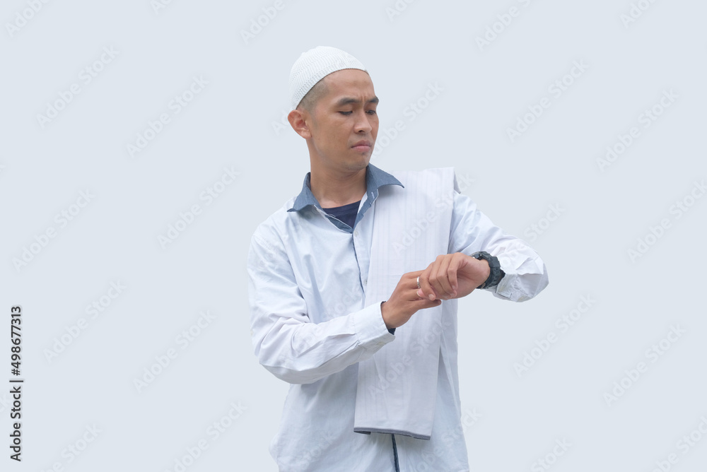 portrait of muslim man checking time in his watch