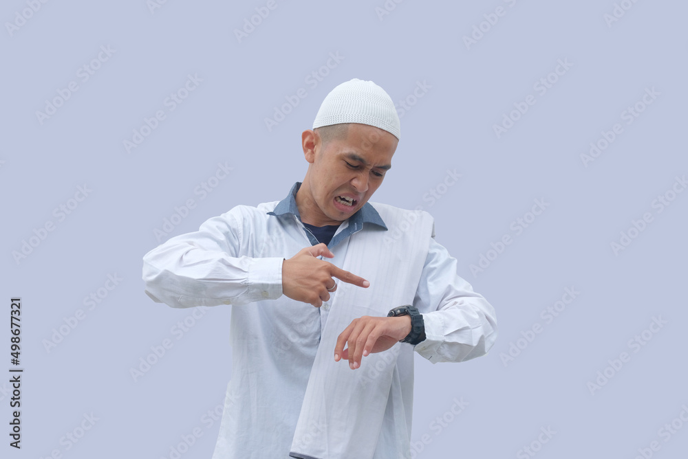angry reaction of muslim man while pointing finger to his watch angry reaction of muslim man while pointing finger to his watch