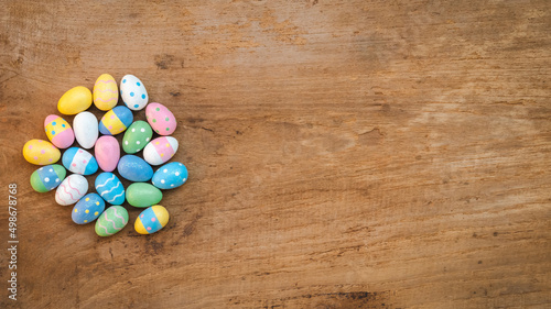 Colorful Easter Egg on a rustic old wood background. Above view with copy space.