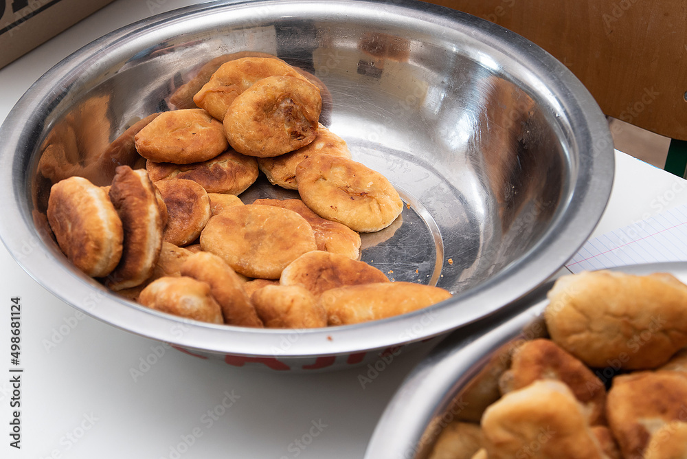 cooking fried pies with potatoes and cabbage in the dining room kitchen