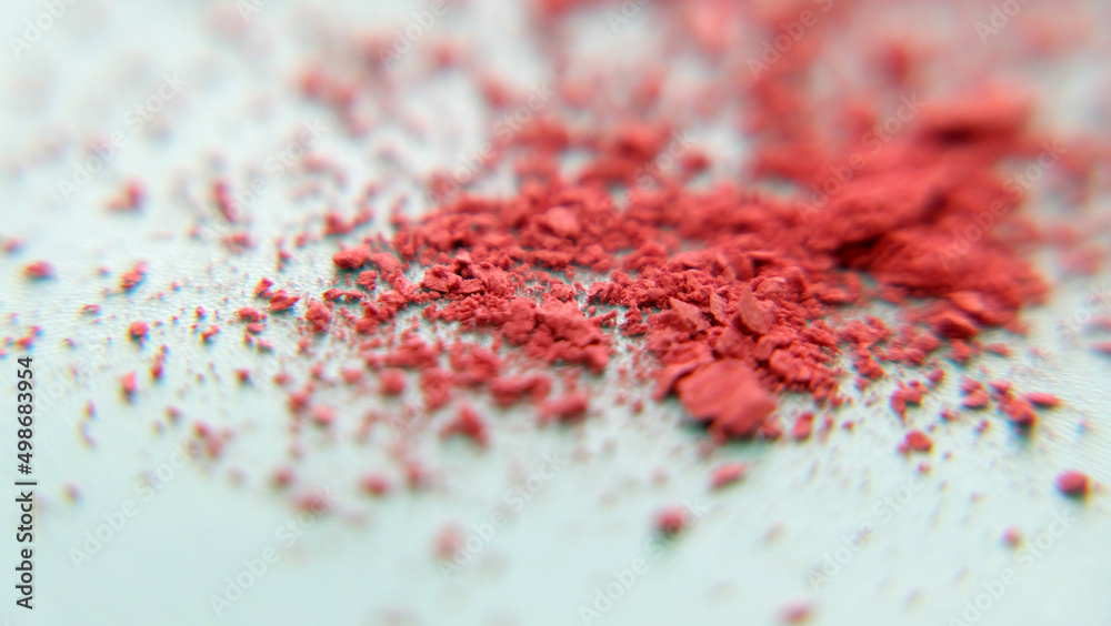 Closeup of a pile of red makeup powder crumbled into small pieces. Closeup of a pile of red makeup powder crumbled into small pieces.
