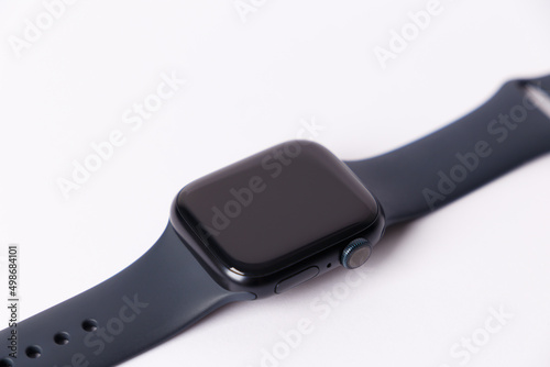 A smartwatch isolated on a white background. Black smartwatch with insulated wrist with open strap. Modern design for high-tech smartwatch and sport technology concept. Close up. Top side view.
