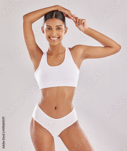 Im in great shape, not by chance but by effort. Shot of a fit young woman posing in her underwear against a studio background.