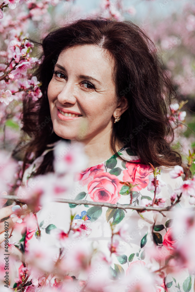 beautiful woman in the garden of flowering peach trees in spring beautiful woman in the garden of flowering peach trees in spring