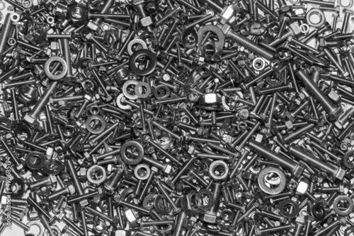 A lot of bolts nuts and washers on a white background.