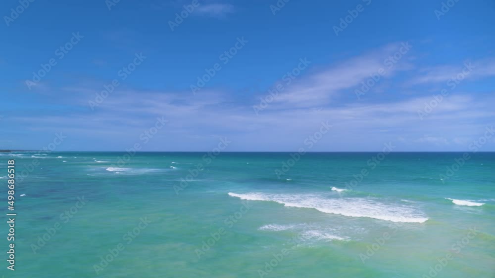 Open ocean under blue cloudy sky. White sea waves on turquoise water. Rest on the sea. Wave bursts on open water. Calm on the sea. Cruise. Open ocean under blue cloudy sky. White sea waves on turquoise water. Rest on the sea. Wave bursts on open water. Calm on the sea. Cruise.