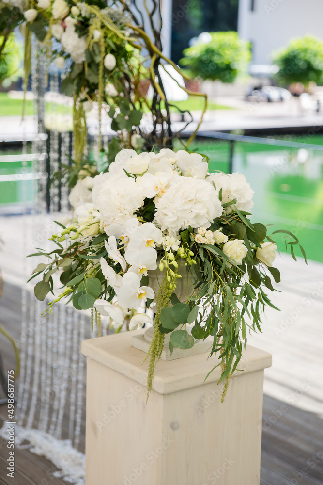 floristry vase with natural flowers orchids hydrangea arch