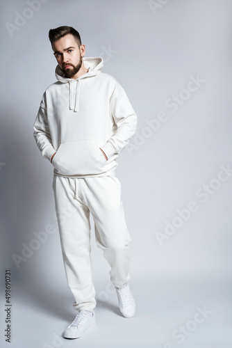 Handsome man wearing blank white hoodie and pants photo