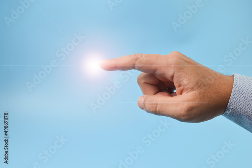 Man finger pointing with light. Innovation and technology concept.