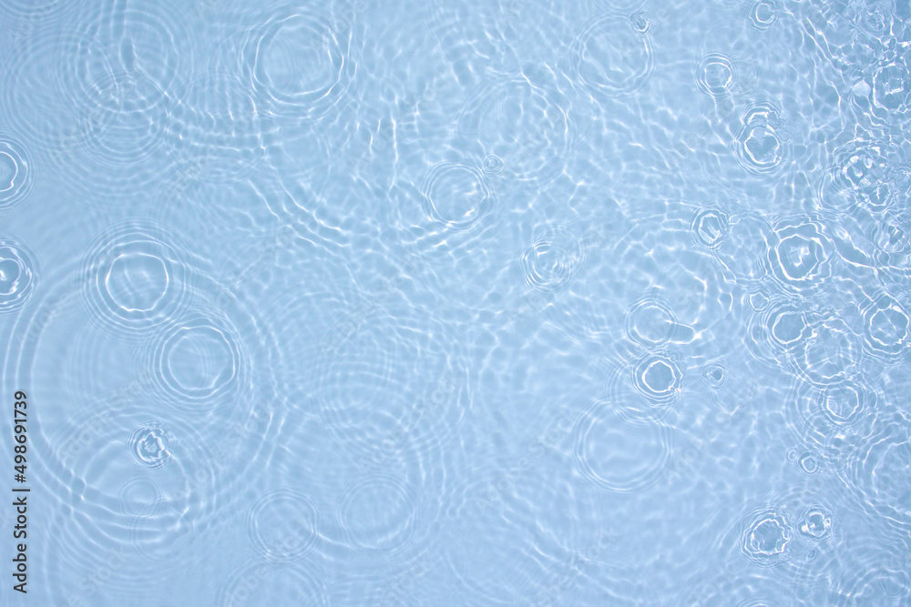 Transparent blue colored clear water surface texture with ripples, splashes and bubbles. Abstract nature background Water waves in sunlight with copy space Cosmetic moisturizer micellar toner emulsion Transparent blue colored clear water surface texture with ripples, splashes and bubbles. Abstract nature background Water waves in sunlight with copy space Cosmetic moisturizer micellar toner emulsion