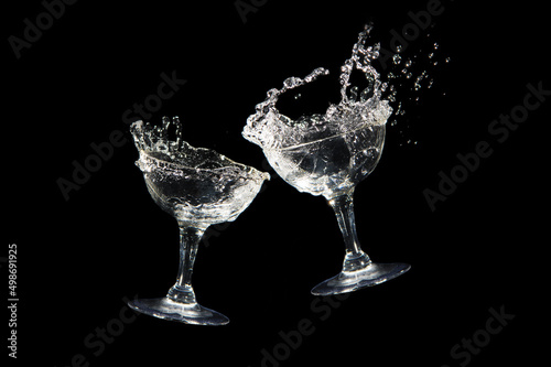 Cheers with two wine glasses isolated on black