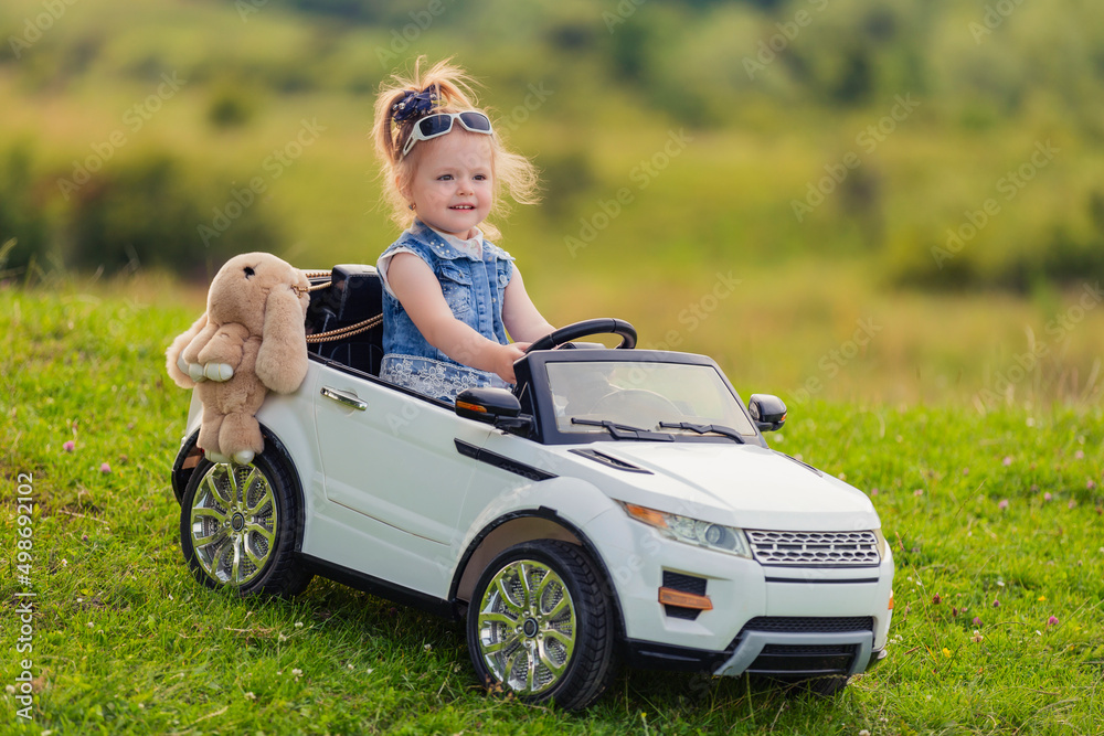 child rides in his car in nature child rides in his car in nature